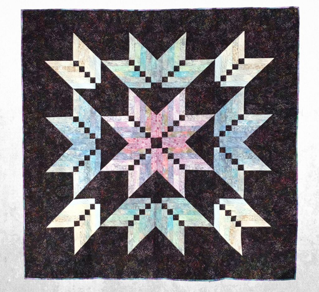 Dramatic black and pastel queen-sized quilt.