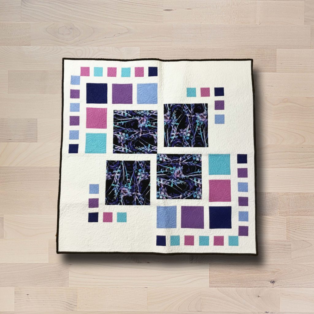 Square modern-style table topper with aqua, raspberry, plus and black accents.